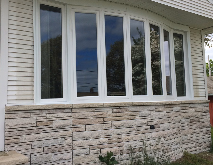 Bay window installation above stone veneer